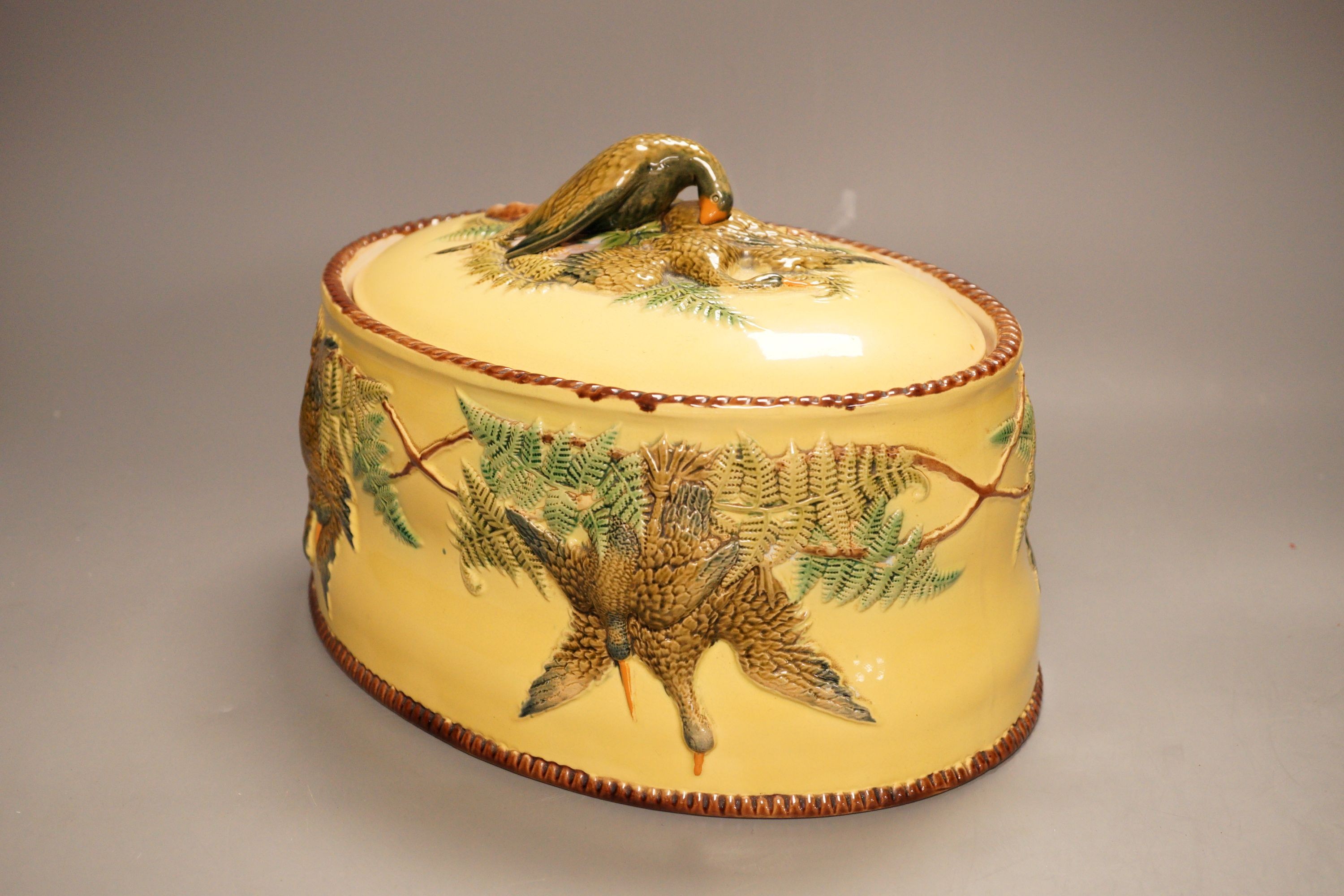 A Continental majolica game tureen with floral and bird relief, 18cm tall